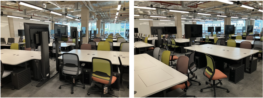 Room with lots of rows table and chairs. There are monitors and pop up computers on each table.